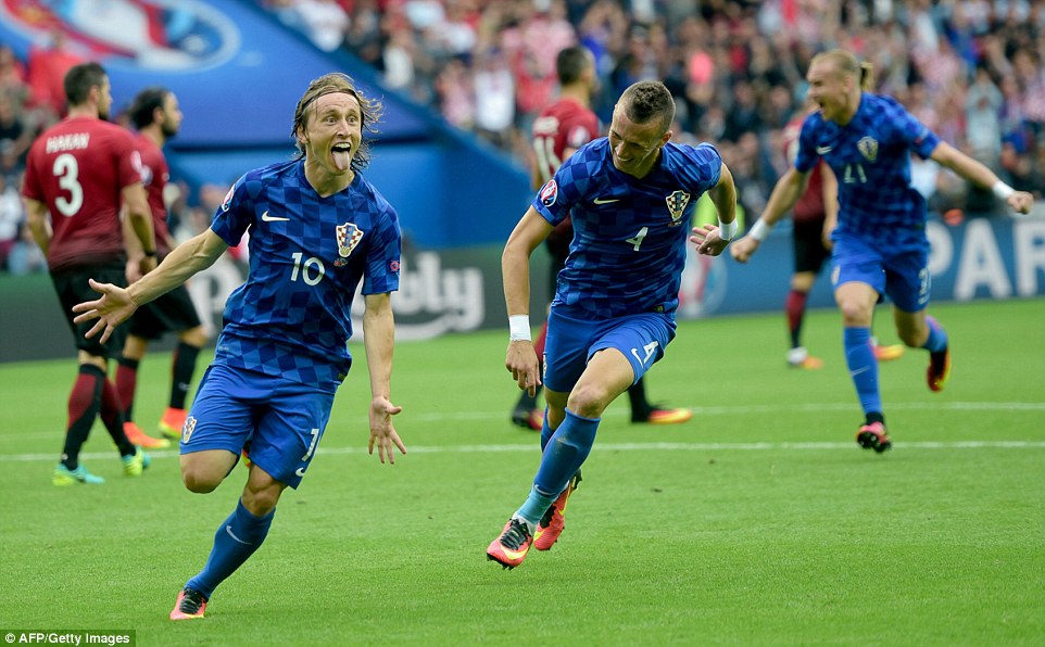 Real Madrid man Modric wheels away to lead the celebrations with his Croatia team-mates after his stunning strike against Turkey